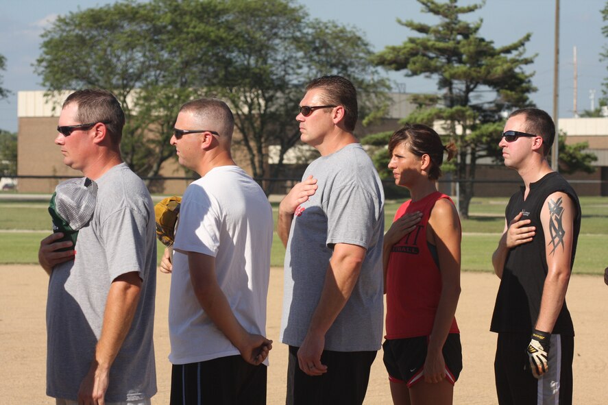 WRIGHT-PATTERSON AIR FORCE BASE, Ohio – Reservists from the 445th Airlift Wing cover their hearts while the National Anthem is playing at the third annual Air Force Sergeants Association Active Duty vs. Reserves Softball Challenge July 24. (U.S. Air Force photo/Senior Airman Robert Nelson)