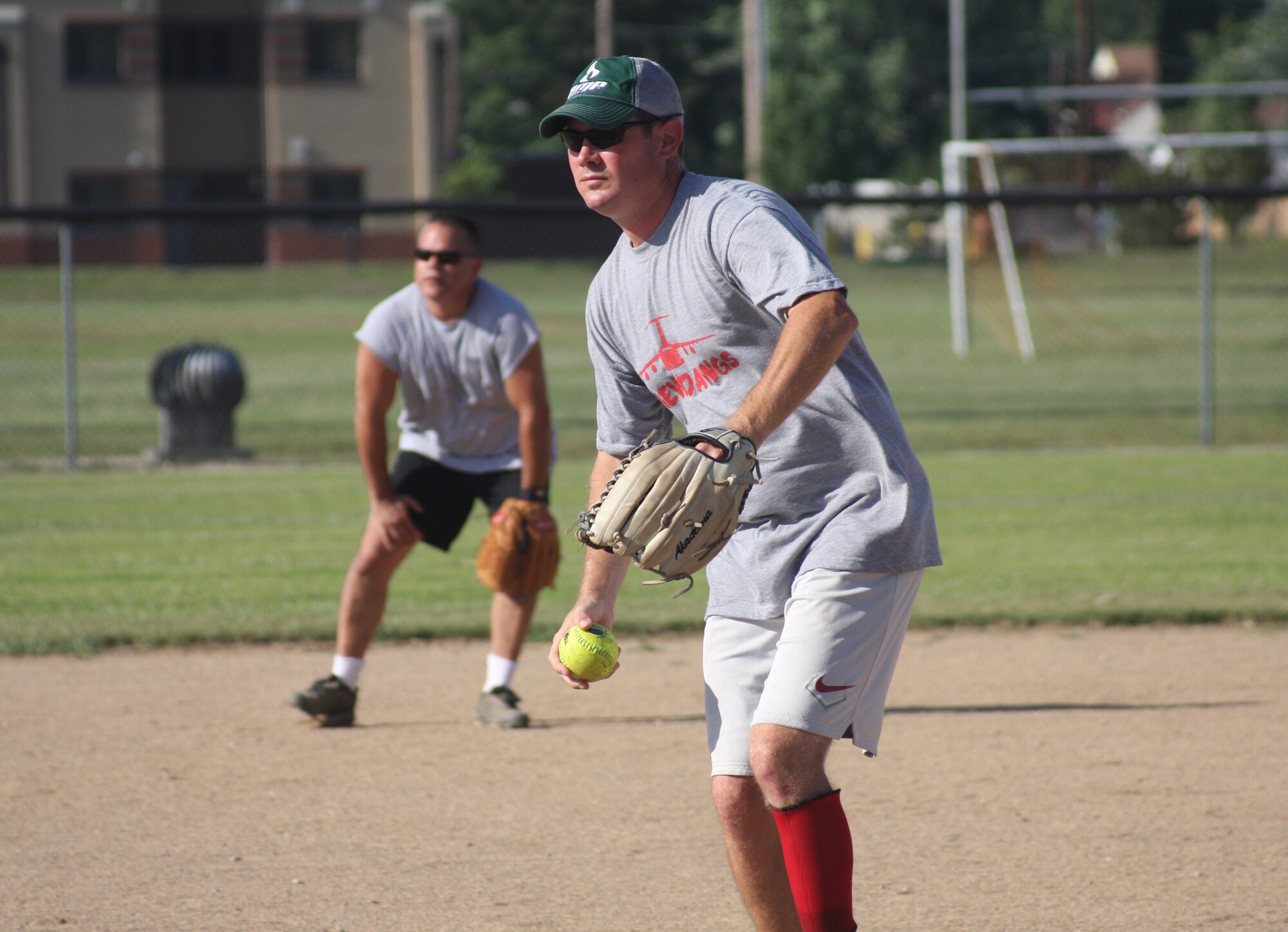 WRIGHT-PATTERSON AIR FORCE BASE, Ohio –Tech Sgt. John Stevens, 445th Aircraft Maintenance Squadron, delivers a pitch while Maj. John Marang, 87th Aerial Port Squadron, stands in the ready position at short-stop during the Third Annual Air Force Sergeants Association Active Duty vs. Reserves Softball Challenge July 24. (U.S. Air Force photo/Senior Airman Robert Nelson)