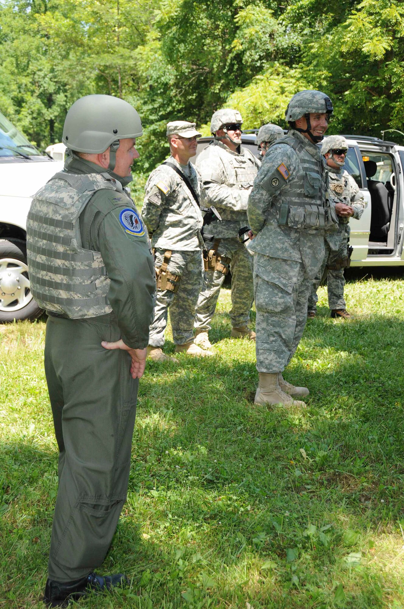 Col. Brian Miller, Commander of the 185th Air Refueling Wing, left, shares a smile with Brig. General Timothy Orr, the Adjutant General for the State of Iowa, right foreground, as the senior Iowa National Guard leaders send-off members of Iowa's 734th Agri-Business Development Team from Camp Atterbury, Ind., to their agricultural mission in Afghanistan.