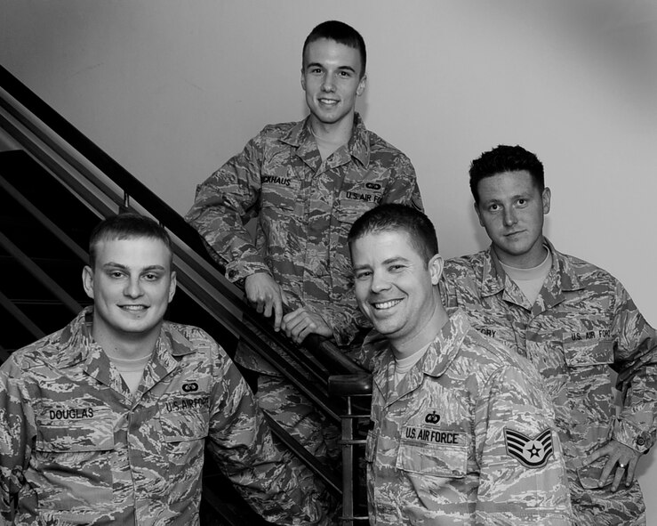 RAF MILDENHALL, England – Staff Sgts. Patrick Glennon, Alan Douglas and Senior Airmen Zachary Bickhaus and Christopher Story, 100th Operations Support Squadron, received recognition as outstanding performers for their situational awareness in dealing with an air traffic alert situation July 28.  One unidentified light aircraft and a helicopter wandered into the flight path during two approach attempts and the prompt actions of the Air Traffic Control team tower diverted both possible collisions.  (U.S. Air Force photo/Staff Sgt. Christopher L. Ingersoll)