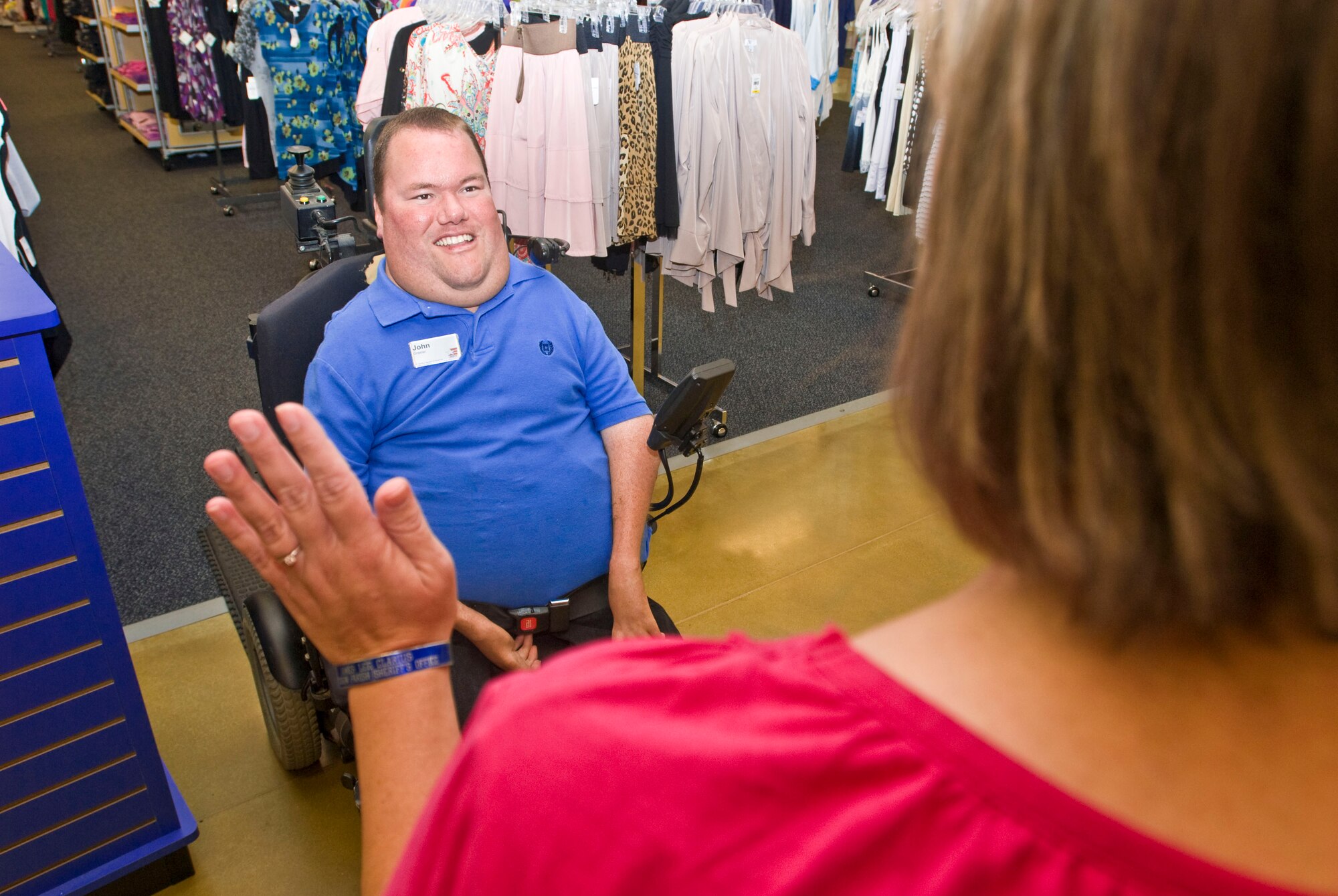 John Perry, Army and Air Force Exchange Service store associate, greets in exchange customer July 27. The Jasper, Ala., native has dedicated 10 years of service and provides quality customer service and guidance to Little Rock exchange patrons. (U.S. Air Force photo by Staff Sgt. Nestor Cruz)