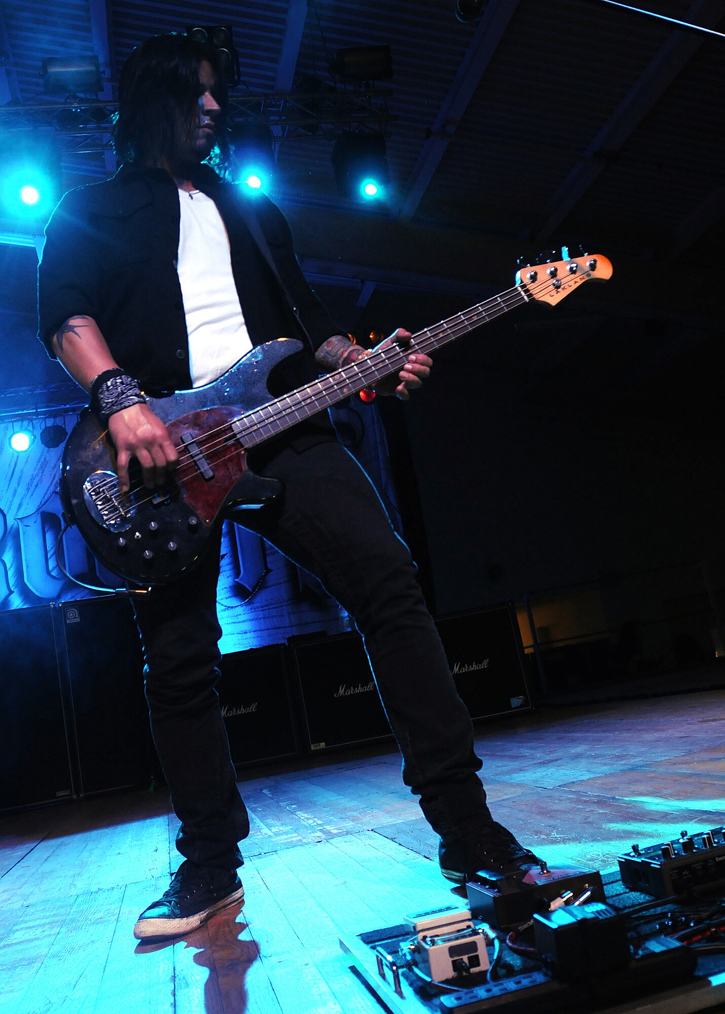 Tobin Esperance, Papa Roach bassist, rocks out during the group?s performance July 25 at the Personnel Alert Holding Area.   Papa Roach?s first major label release was the triple-platinum debut album Infest in 2000.  Papa Roach and Dear Superstar Preformed to Aviano Airmen and their families as part of Service Organization-sponsored show.  (U.S. Air Force photo/Senior Airman Tabitha M. Lee)