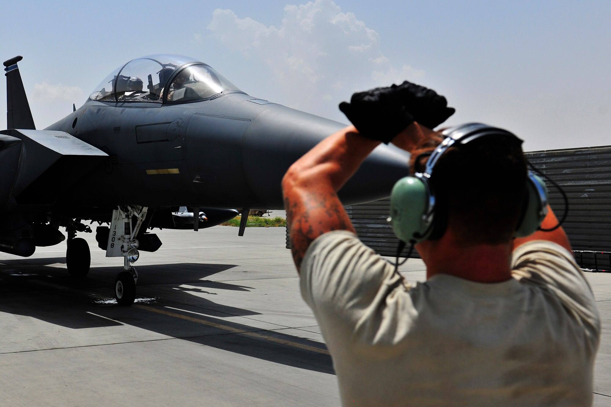 Senior Airman Donald Jenkins, a crew chief assigned to the 455th Expeditionary Aircraft Maintenance Squadron, marshals an F-15E Strike Eagle for takeoff at Bagram Airfield, Afghanistan, July 27, 2010. Airman Jenkins is a native of Riverside, Calif. (U.S. Air Force photo/Staff Sgt. Christopher Boitz)