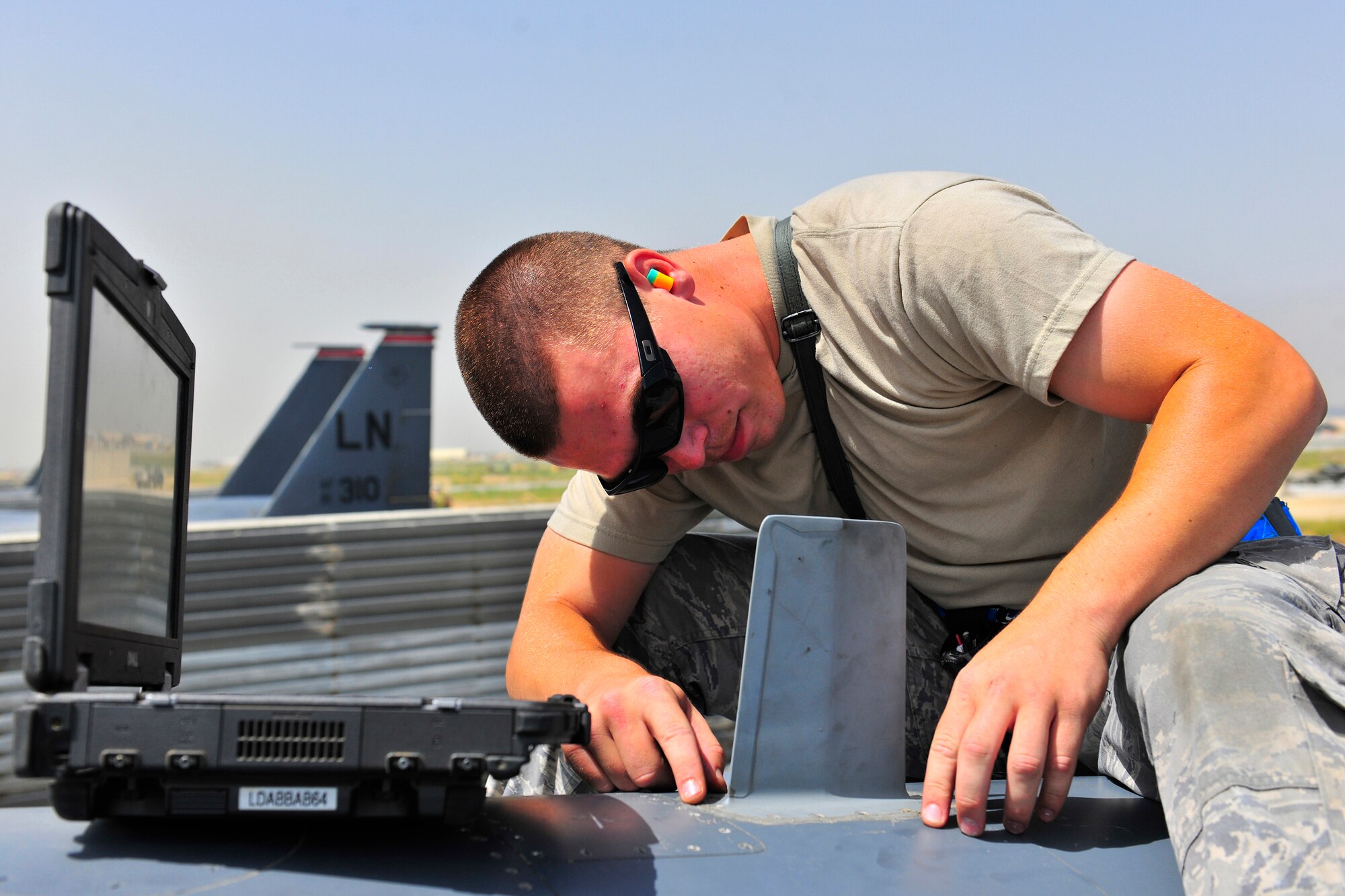 Senior Airman Brandon Blide, an avionics systems journeyman assigned to the 455th Expeditionary Aircraft Maintenance Squadron, inspects a UHF antenna on an F-15E Strike Eagle at Bagram Airfield, Afghanistan, July 27, 2010. The antenna transmits and receives communications from other aircraft and ground units. Airman Blide is a native of Marietta, Ga. (U.S. Air Force photo/Staff Sgt. Christopher Boitz)