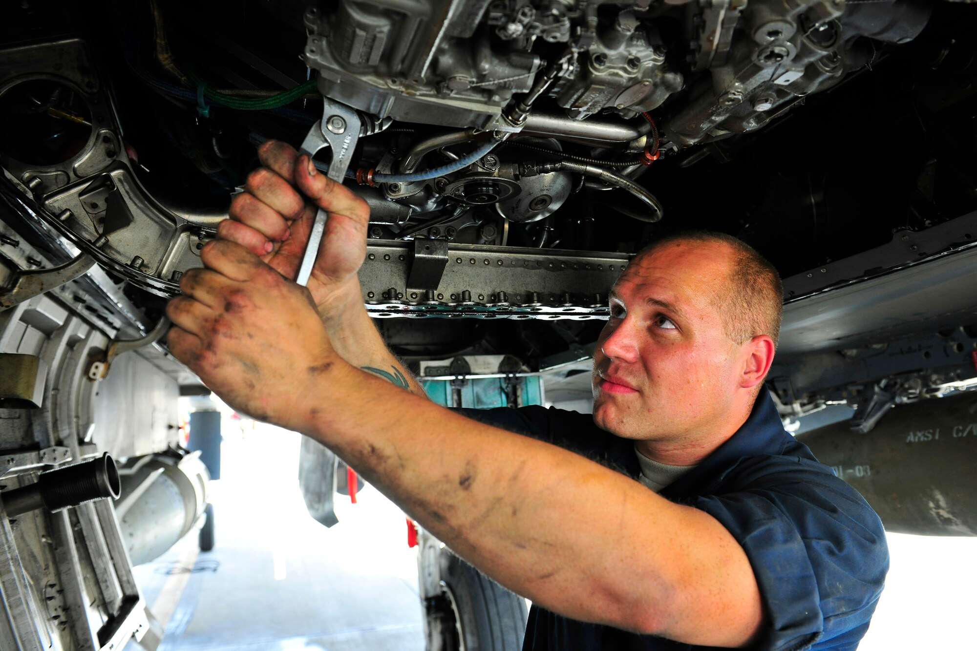 Senior Airman Rulon Sasso, an aerospace propulsion journeyman assigned to the 455th Expeditionary Aircraft Maintenance Squadron, tightens the main fuel connector on an F-15E Strike Eagle at Bagram Airfield, Afghanistan, July 27, 2010. The connector meters and controls the fuel flow to the aircraft. Airman Sasso is a native of Denver, Colo. (U.S. Air Force photo/Staff Sgt. Christopher Boitz)
