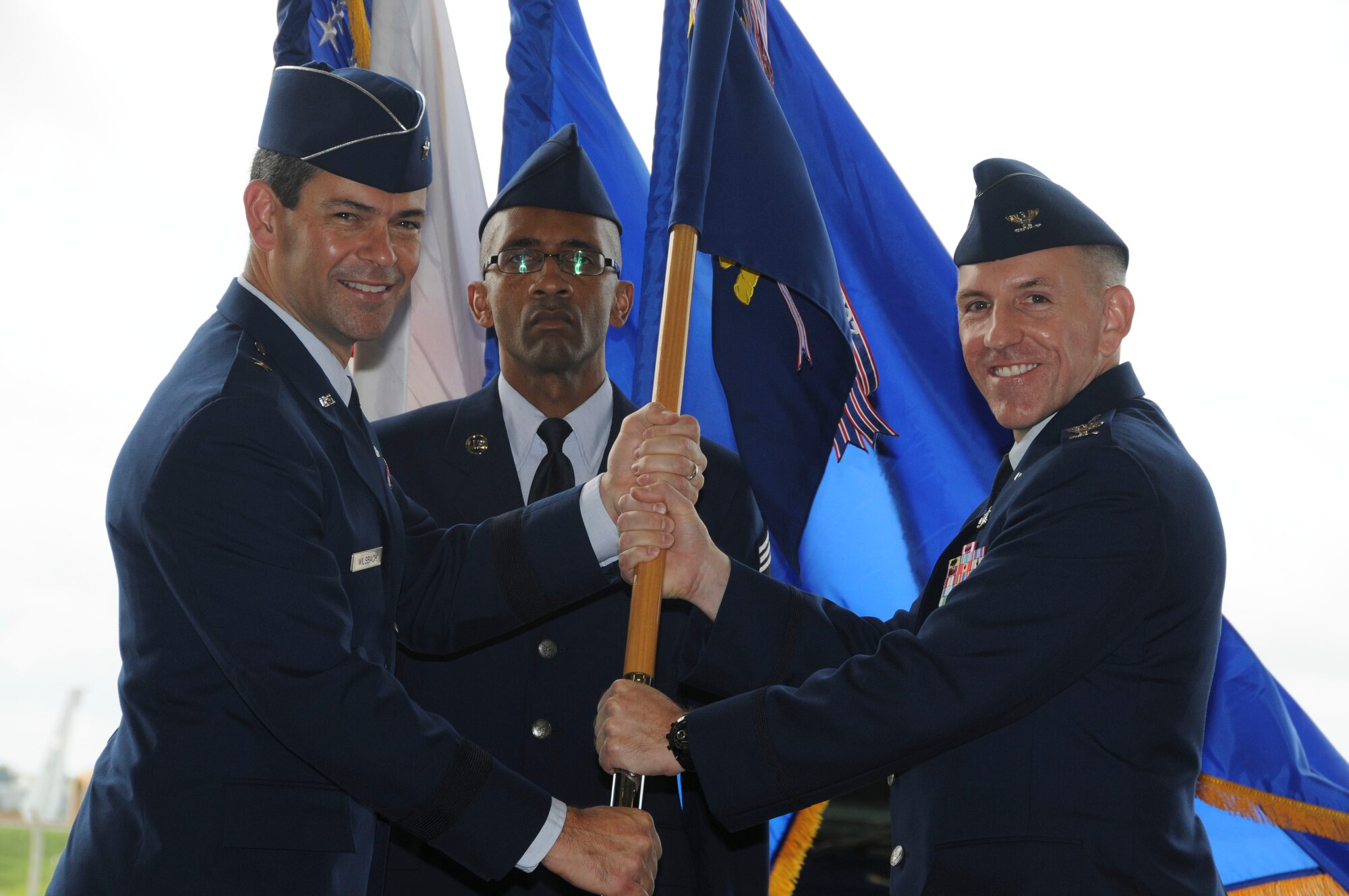 Col. Roftiel Constantine (right), incoming 18th Mission Support Group commander, accepts the 18th MSG guidon from Brig. Gen. Ken Wilsbach, 18th Wing commander during a change of command ceremony July 27. (U.S. Air Force photo / Staff Sgt. Darnell Cannady)