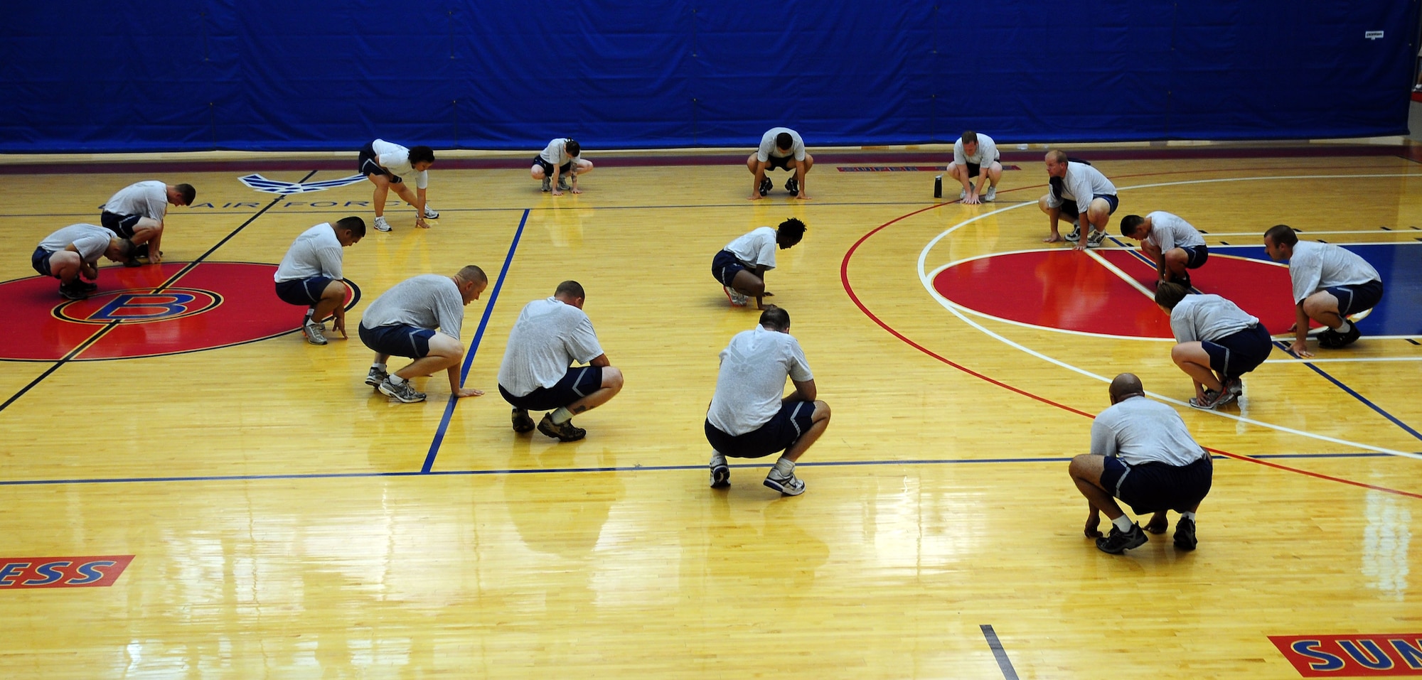 ANDERSEN AIR FORCE BASE, Guam - Senior Airman Britney Robinson, fitness improvement program instructor, leads stretches after a work-out session at the Coral Reef Fitness Center July 27. The program helps individuals get into better shape for physical training tests. (U.S. Air Force photo by Airman Whitney Amstutz)