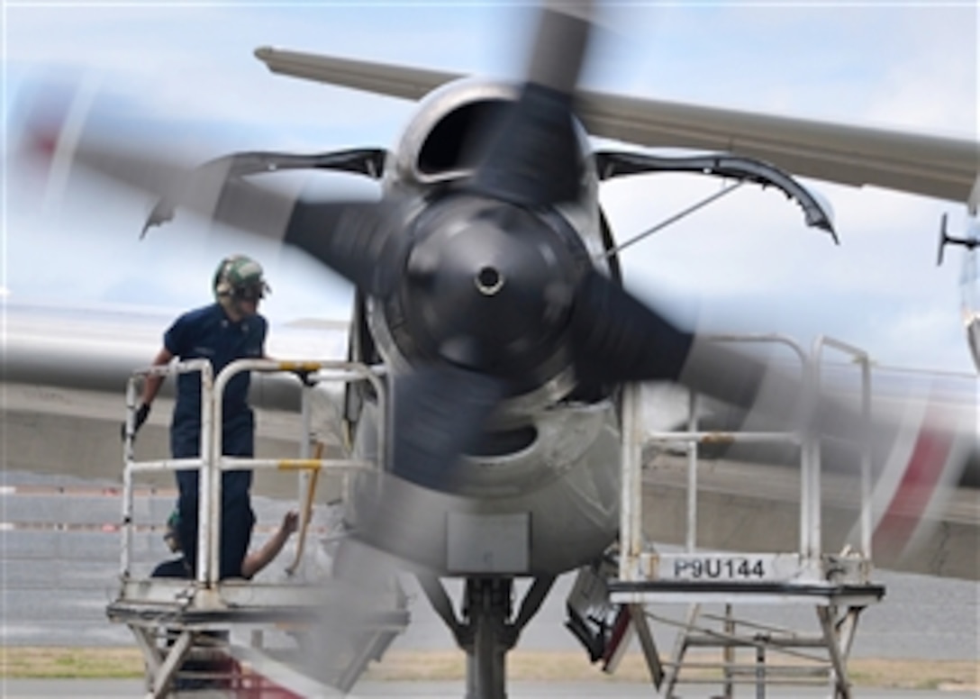 U.S. Navy Petty Officer 3rd Class Alfred Barreta, of Patrol Squadron 40, inspects the engine compartment of a P-3C Orion aircraft for leaks in Kaneohe Bay, Hawaii, on July 23, 2010.  