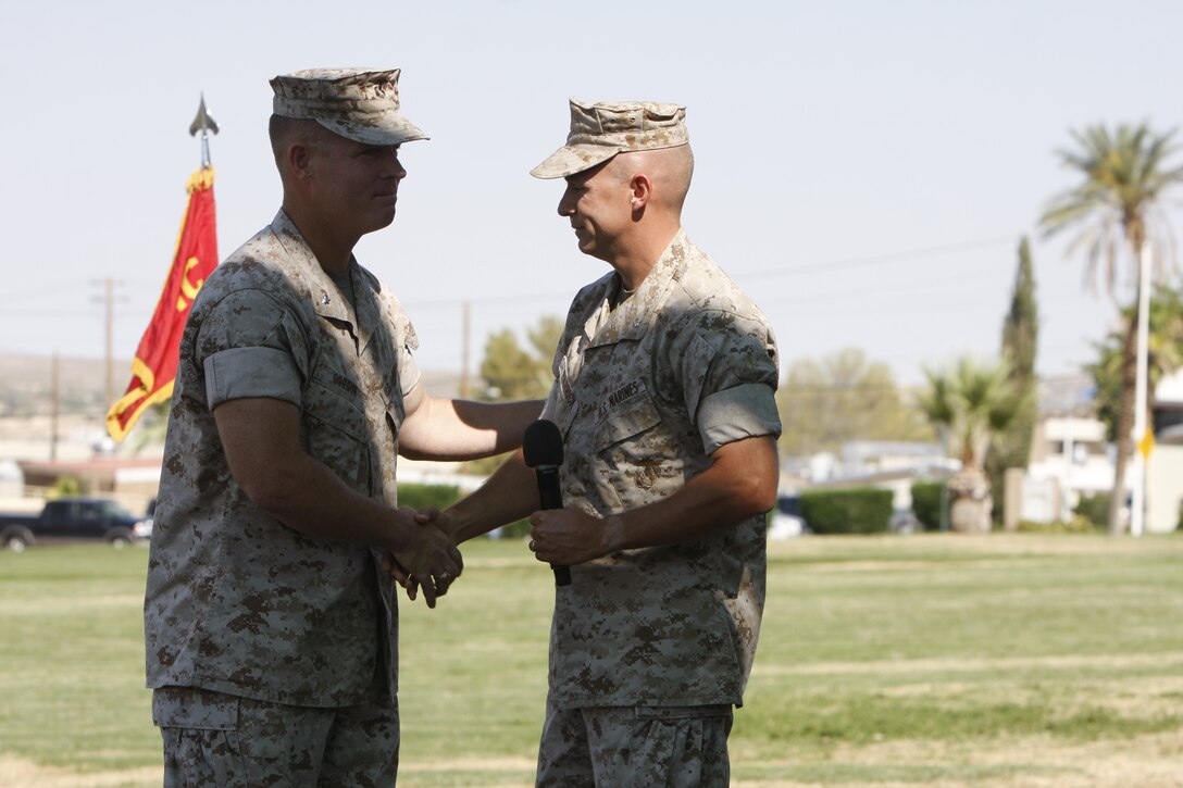 Lieutenant Col. Tom Gordon [left] relinquished the command of 1st Tank Battalion to Lt. Col. Timothy Barrick during a change of command ceremony at Lance Cpl. Torrey L. Gray Field July 29.