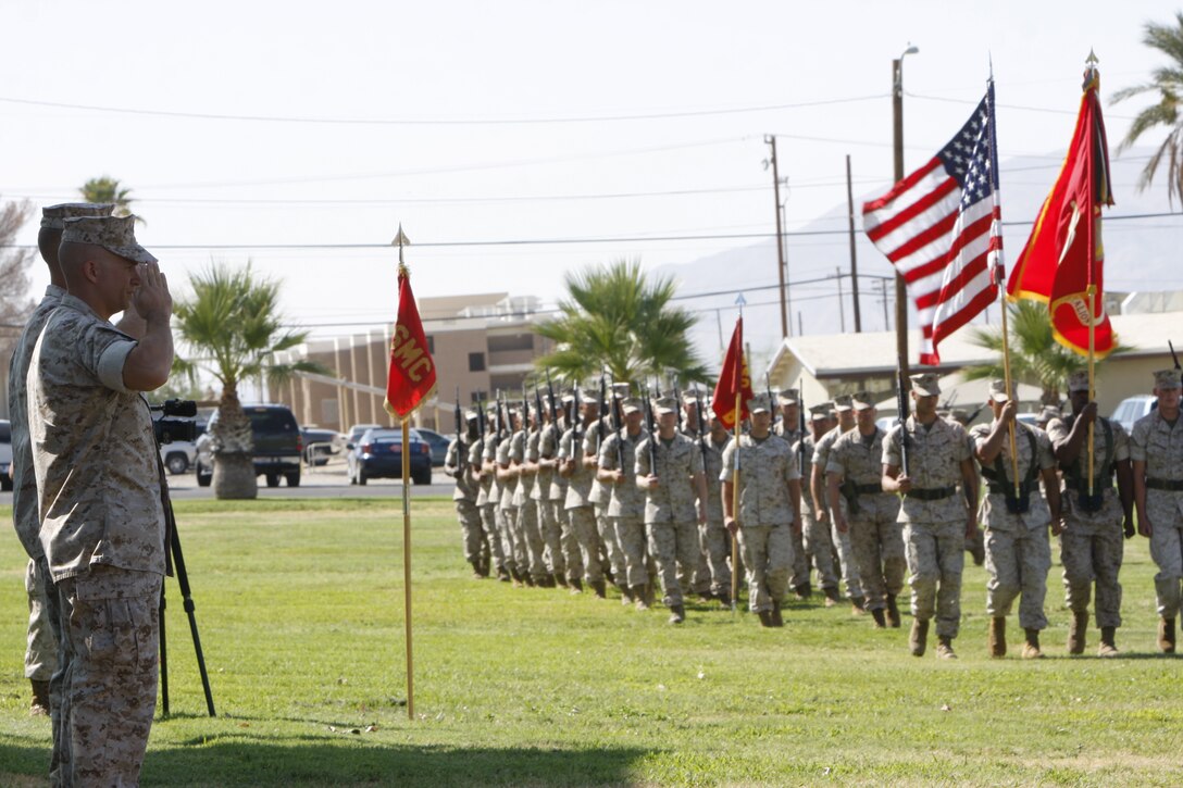 Lieutenant Cols. Timothy Barrick and Tom Gordon salute the Marines and sailors of 1st Tank Battalion during a pass in review as part of a change of command ceremony at Lance Cpl. Torrey L. Gray Field July 29. During the ceremony, Barrick assumed command of the battalion from Gordon.