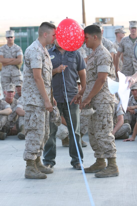 MARINE CORPS AIR GROUND COMBAT CENTER TWENTYNINE PALMS, Calif.-- Marines from the 3rd Light Armored Calvary Battalion prepare to race down the line during a game at the Barracks Bash July 29 at the 3rd LAR ramp. The game included two Marines placing a balloon between their heads and run down the line and back while racing another team of Marines.