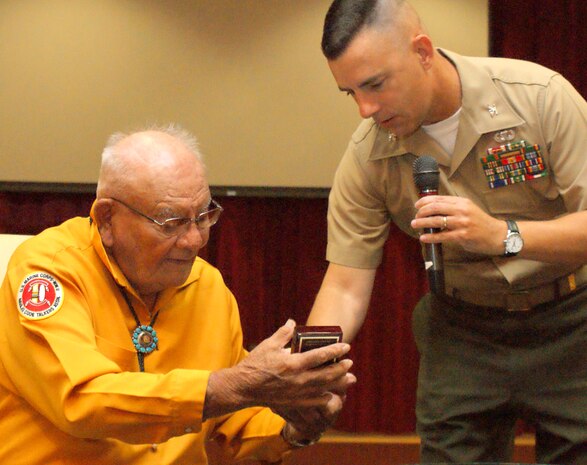 Keith Little, a Navajo who served in the Marine Corps during World War II, receives a gift from Colonel Alan Pratt, Marine Corps Tactical Systems Support Activity’s (MCTSSA) Commanding Officer, at MCTSSA’s Acquisition Excellence Day.