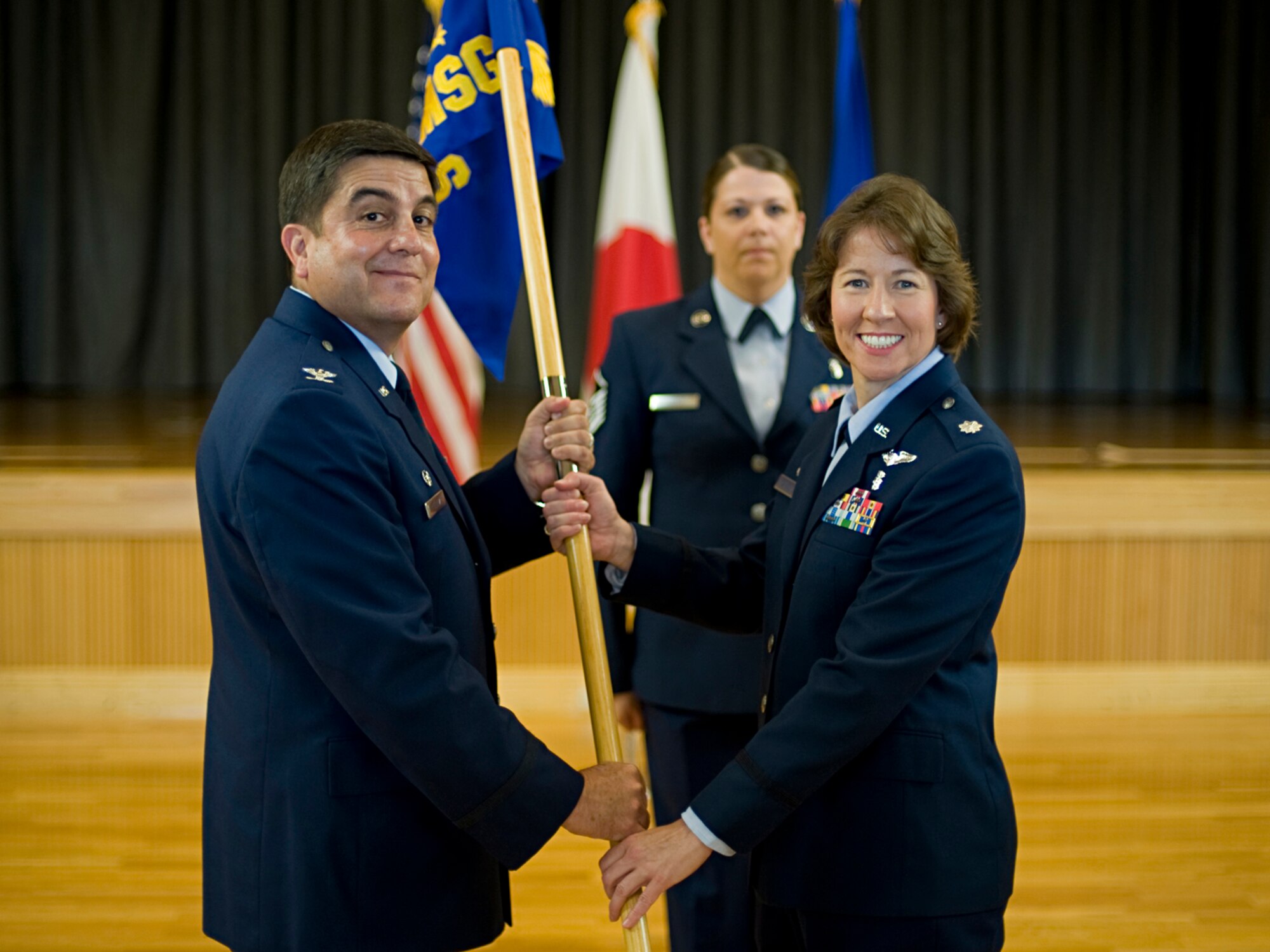 MISAWA AIR BASE, Japan -- Lt. Col. Mary Carlisle receives the 35th Surgical Operations Squadron guidon from Col. Guillermo Tellez, 35th Medical Group commander, during a change of command ceremony July 29 at the Collocated Club. Colonel Carlisle assumed command of the 35th MSGS from Lt. Col. Suk Hi Ross. Colonel Carlisle comes from Bolling Air Force Base, Washington, D.C., where she served as 597th Medical Group chief nurse and chief of education and training. (U.S. Air Force photo/Senior Airman Jamal D. Sutter)