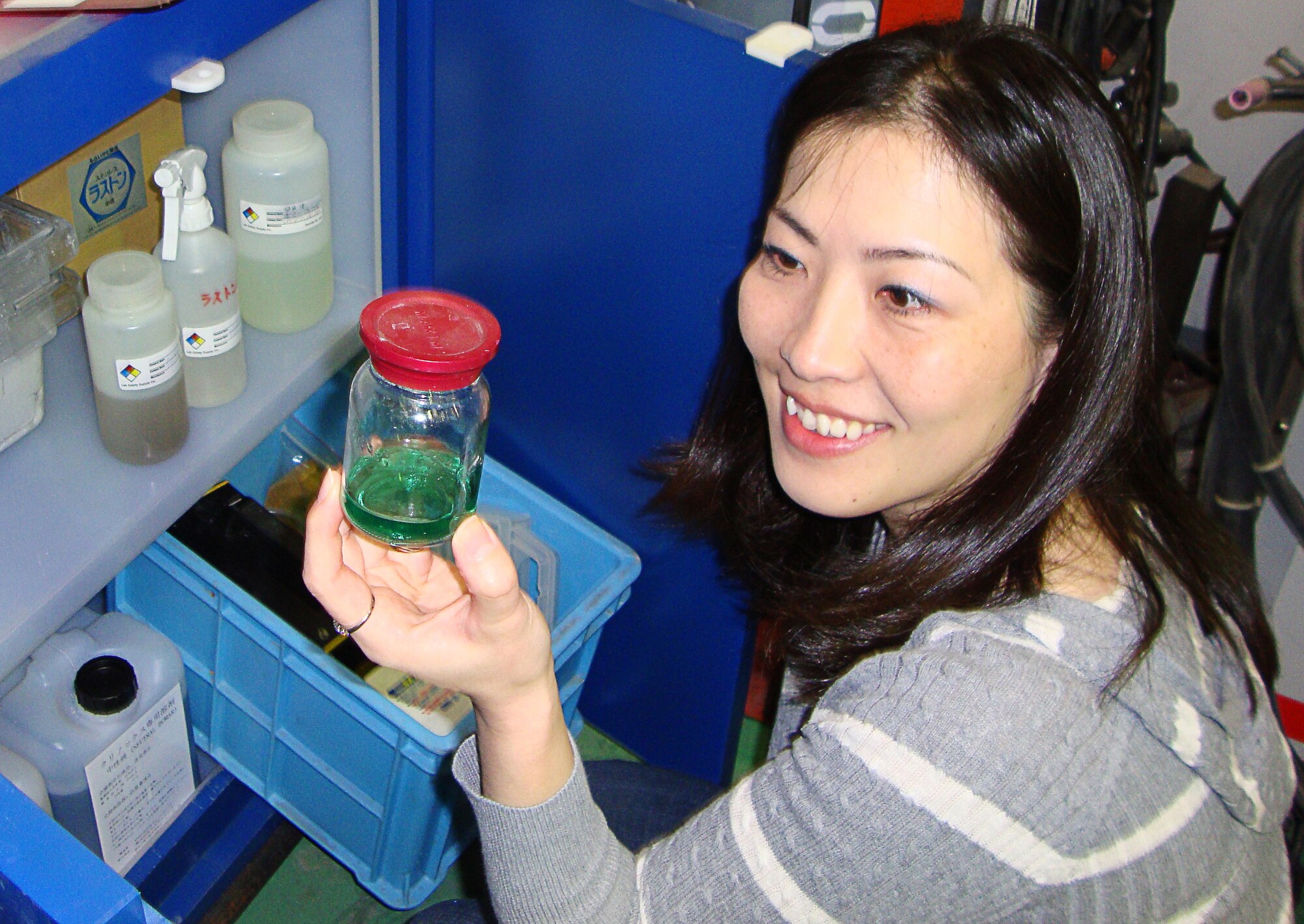 YOKOTA AIR BASE, Japan -- Noriko Kosukegawa, a hospital safety officer for the 374th Medical Group, shows an assessor how hazardous material is stored. The Environmental, Safety and Occupational Health Compliance Assessment Program is an Air Force wide comprehensive program designed to ensure that USAF personnel are working in safe, healthy environments that are not damaging the environment. Assessors look for any deficiencies or deviations from laws, regulations, instructions and policies that could result in a negative environmental, health or safety impact. (Courtesy photo)                 
