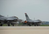 Two F-16 Fighting Falcon aircraft take off on a combat training mission July 28, piloted by Capt. Christopher Moeller and Capt. David Bennett, both of Osan's 36th Fighter Squadron. (U.S. Air Force photo/Senior Master Sgt. Paul Holcomb)