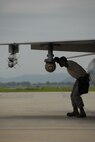 An Airman makes final adjustments to ordnance on an F-16 Fighting Falcon assigned to Osan's 36th Fighter Squadron before the pilot takes off on a combat training mission July 28. (U.S. Air Force photo/Senior Master Sgt. Paul Holcomb)