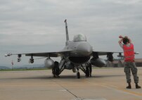 Airmen pull chocks after completing preflight checks of an F-16 Fighting Falcon prior to takeoff on a combat training mission July 28. (U.S. Air Force photo/Senior Master Sgt. Paul Holcomb)