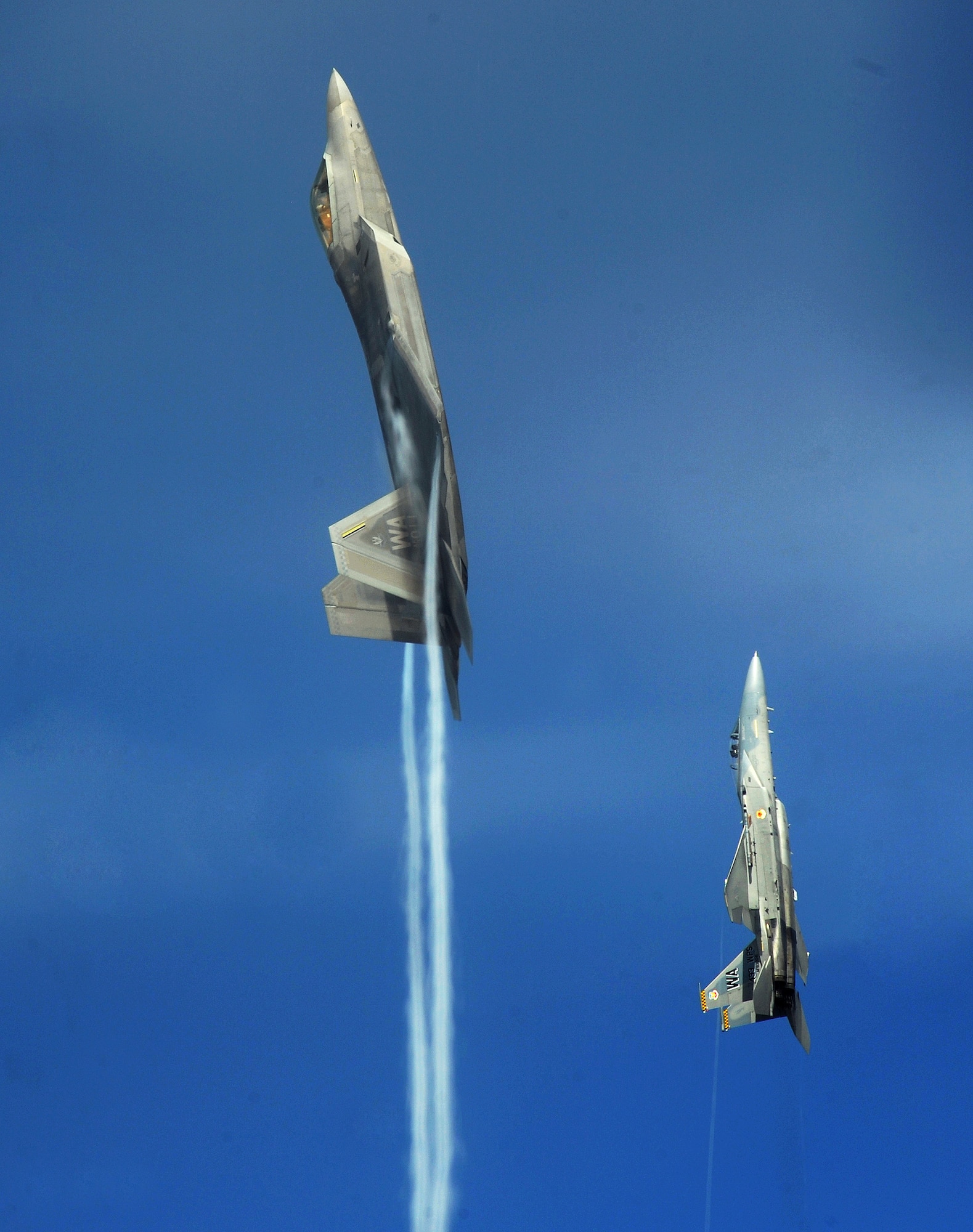 An F-22 Raptor and F-15 Eagle from the U.S. Air Force Weapons School's 433rd Weapons Squadron pull into a vertical climb over the Nevada Test and Training Range July 16, 2010. (U.S. Air Force photo/Master Sgt. Kevin J. Gruenwald)
