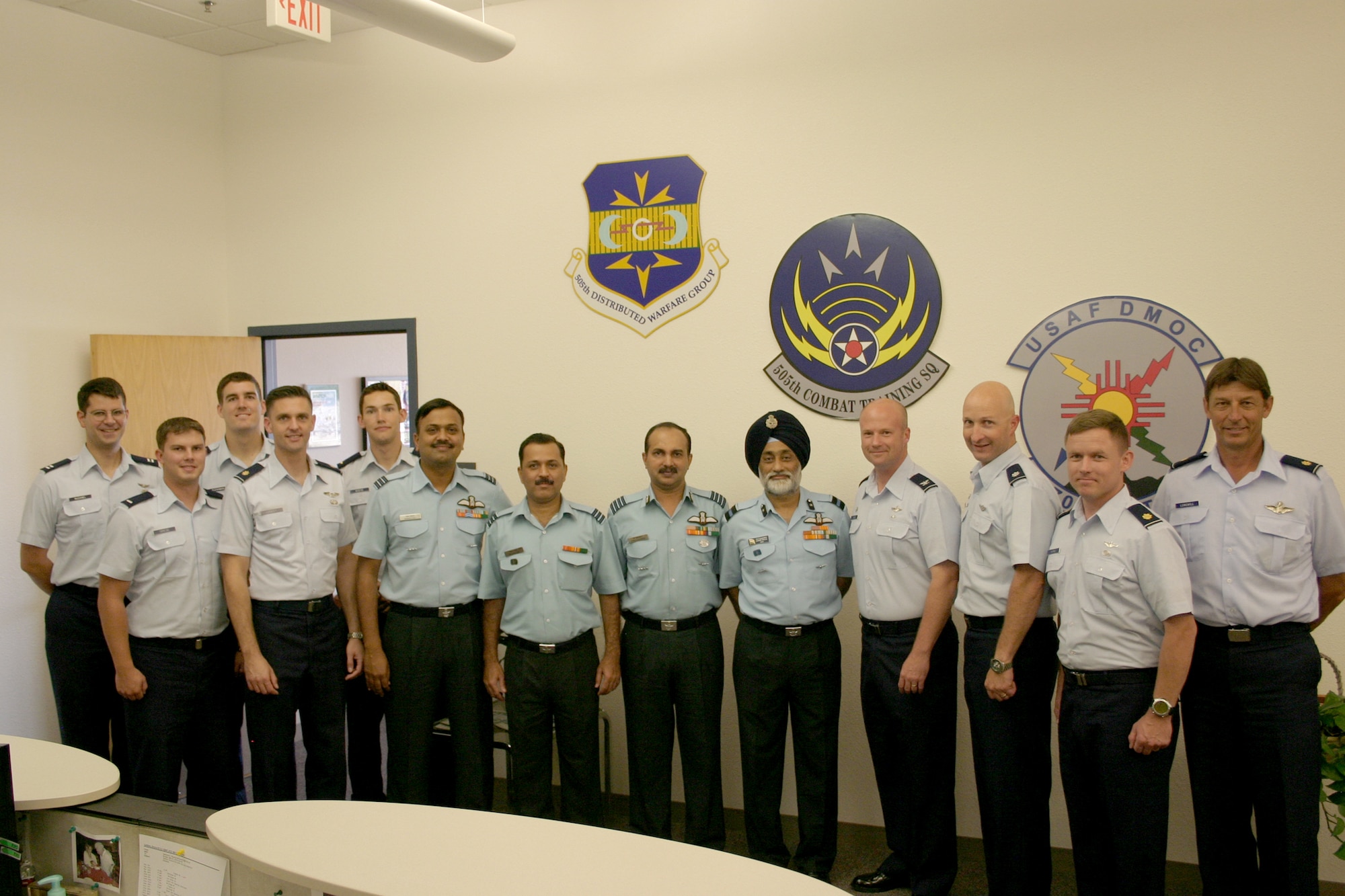 Senior Indian air force leaders visited the 705th Combat Training Squadron at Kirtland Air Force Base, N.M., July 26 and 27 to learn more about the employment of simulators for basic pilot training and for combined coalition operations. Pictured (from left) are: Capt. Ryan McDaniel, 1st Lt. Nick Griese, 1st Lt. Alex Fleshman, Maj. Mark Hadley and 2nd Lt. George Boese, all from the 705th CTS; IAF Wing Commander Raman Goel, Wing Commander Mandar Naik, Group Captain Balakrishnan Balachandran, and Air Commodore J.S. Walia; Col Will Reese, 505th Distributed Warfare Group commander; Lt. Col. Dan Pepper, 705th CTS commander; and Majs. Doug Horne and Brian Longwill, 705th CTS. (U.S. Air Force photo/2nd Lt. Sabina Grusnick)