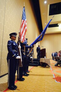 Members of the Randolph Honor Guard present the colors as Staff Sgt. Roy Norwood, 711th Human Performance Wing, Brooks City-Base, Texas, sings the National Anthem at the beginning of the Tuskegee Airmen convention July 29 as Tuskegee Airmen honor the flag prior to the Lonely Eagles Ceremony which recognizes Tuskegee Airmen that have died during the past year. (U.S. Air Force photo/Steve Thurow)