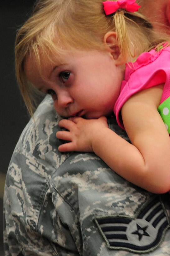 ELLSWORTH AIR FORCE BASE, S.D. – An Ellsworth Airman holds his daughter after returning from a deployment to Southwest Asia, July 28. More than 350 Airmen serving in various roles deployed in support of Operations Iraqi and Enduring Freedom. (U.S. Air Force photo/Airman 1st Class Corey Hook)