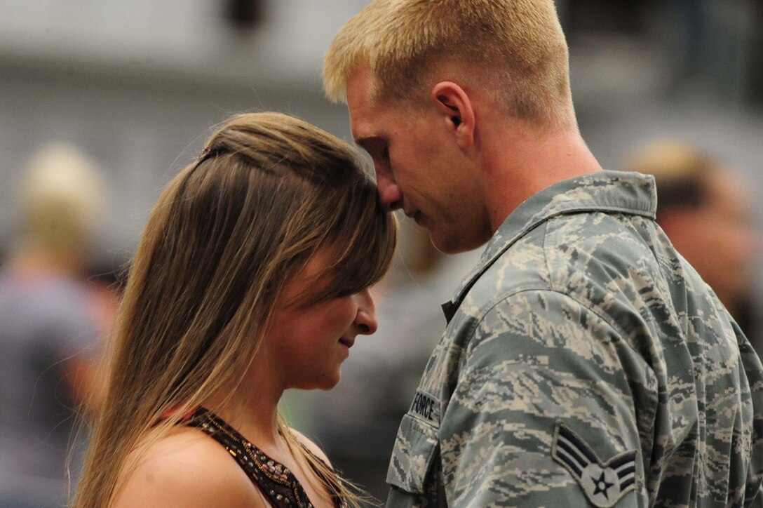 ELLSWORTH AIR FORCE BASE, S.D. – Senior Airman Cole Destatte, 28th Aircraft Maintenance Squadron offensive avionics systems journeyman, shares a moment with his girlfriend Danielle Tompkins after returning from a deployment to Southwest Asia, July 28. Airman Destatte provided support for Operations Iraqi and Enduring Freedom during his deployment. (U.S. Air Force photo/Airman 1st Class Corey Hook)