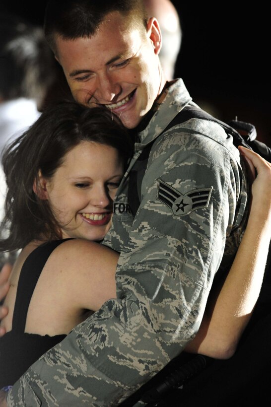 ELLSWORTH AIR FORCE BASE, S.D. – Senior Airman Samuel Coffin, 28th Aircraft Maintenance Squadron offensive avionics systems journeyman, hugs his wife Heidi after returning from a deployment to Southwest Asia, July 28. Senior Airman Coffin provided support for Operations Iraqi and Enduring Freedom during his deployment. (U.S. Air Force photo/Airman 1st Class Corey Hook)