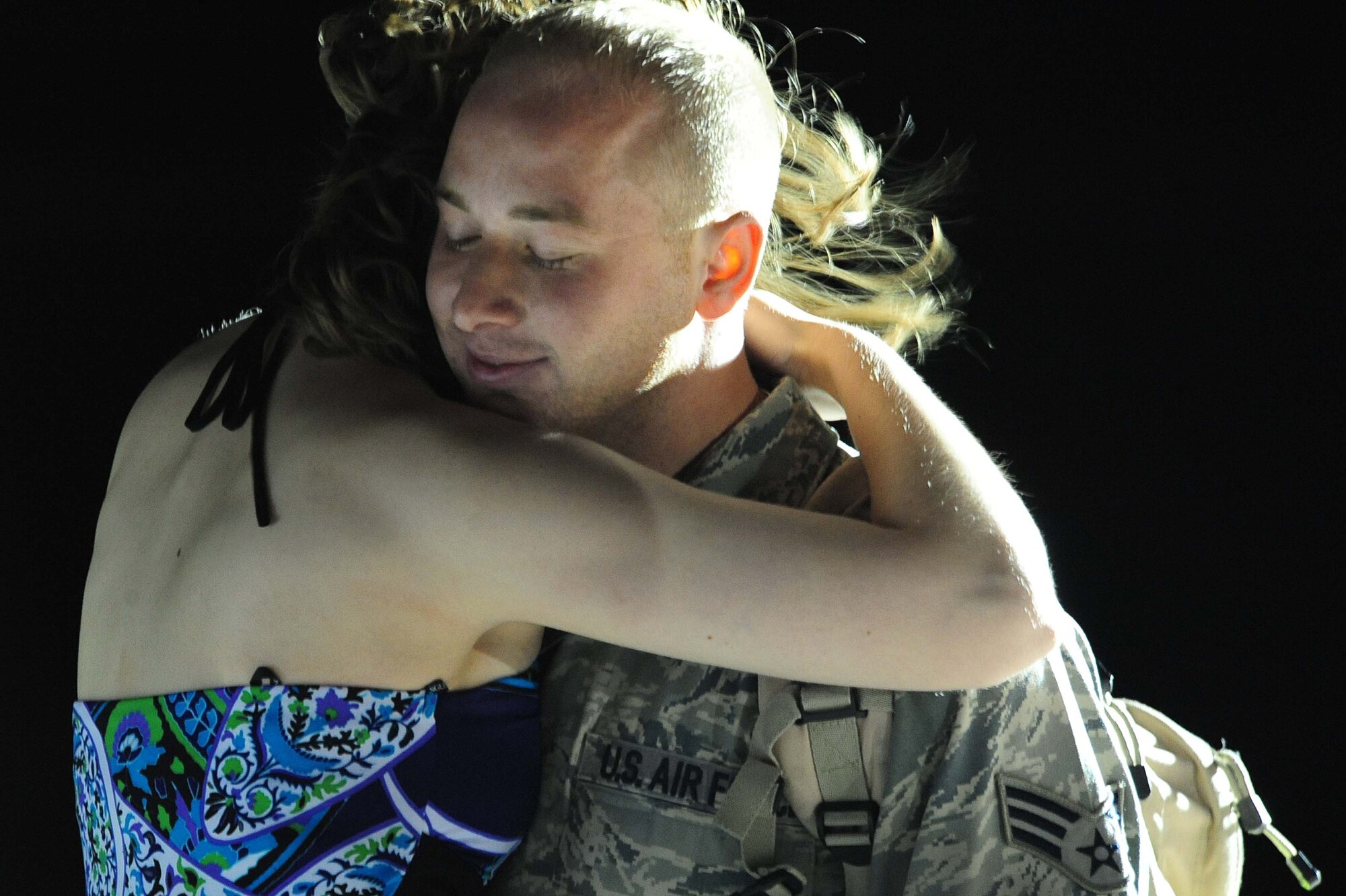 ELLSWORTH AIR FORCE BASE, S.D. – Senior Airman Chad Myers, 28th Maintenance Squadron hydraulics journeyman, hugs his wife Ashley after returning from a deployment to Southwest Asia, July 28. Senior Airman Myers was assigned to the 34th Aircraft Maintenance Squadron during his deployment to Southwest Asia in support of Operations Enduring and Iraqi Freedom. (U.S. Air Force photo/Airman 1st Class Corey Hook)