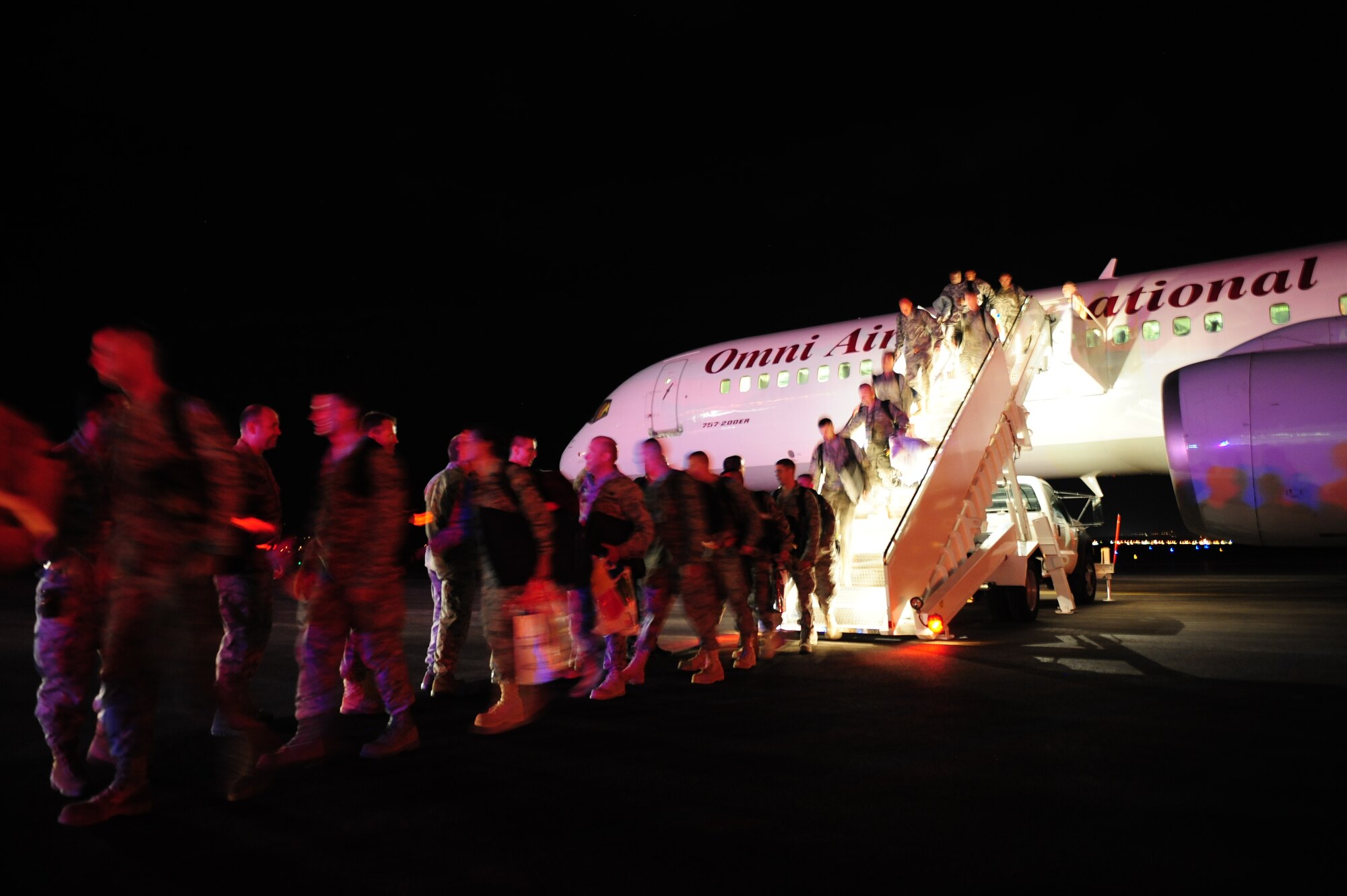 ELLSWORTH AIR FORCE BASE, S.D. – Airmen step off a plane to return from a deployment from Southwest Asia in support of Operations Iraqi and Enduring Freedom, July 28. More than 350 Airmen returned home, with two different arrival times during the day, and were greeted by Ellsworth leaders, their family, friends and co-workers. (U.S. Air Force photo/Airman 1st Class Corey Hook)