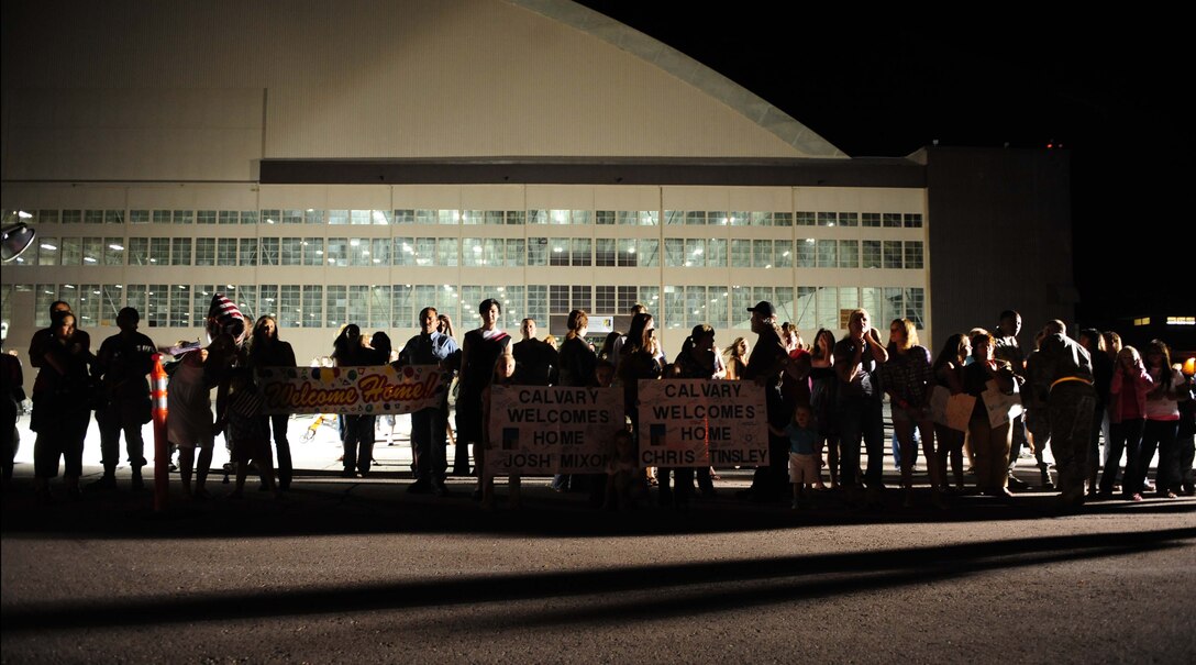 ELLSWORTH AIR FORCE BASE, S.D. – Friends and family members of deployed Airmen stand outside the PRIDE Hangar before the Airmen step off the plane, July 28. More than 350 Airmen from the 34th Bomb Squadron, 28th Aircraft Maintenance Squadron, Munitions Squadron, Operational Support Squadron, Logistics Readiness Squadron and Maintenance Squadron returned home after a six-month deployment to Southwest Asia in support of Operations Iraqi and Enduring Freedom. (U.S. Air Force photo/Airman 1st Class Corey Hook)
