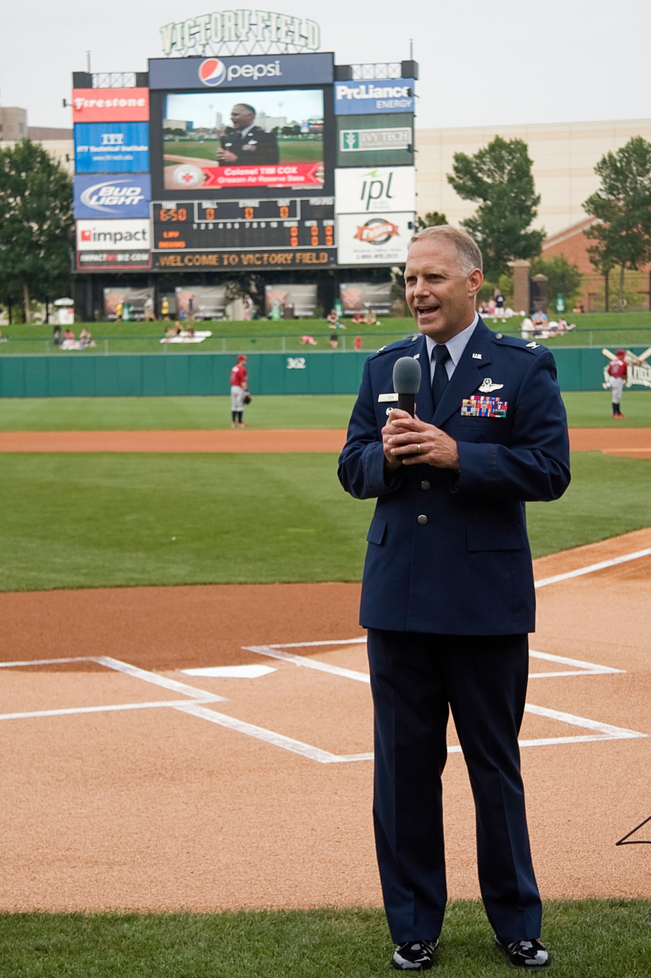 GRISSOM AIR RESERVE BASE, Ind. -- Standing behind home plate at Victory Field in Indianapolis, Col. Tim Cox talks with Indianapolis Indians fans about the mission of the 434th Air Refueling Wing and Air Force Reserve. Colonel Cox, the 434th ARW vice commander. (U.S. Air Force photo/Tech. Sgt. Mark R. W. Orders-Woempner)