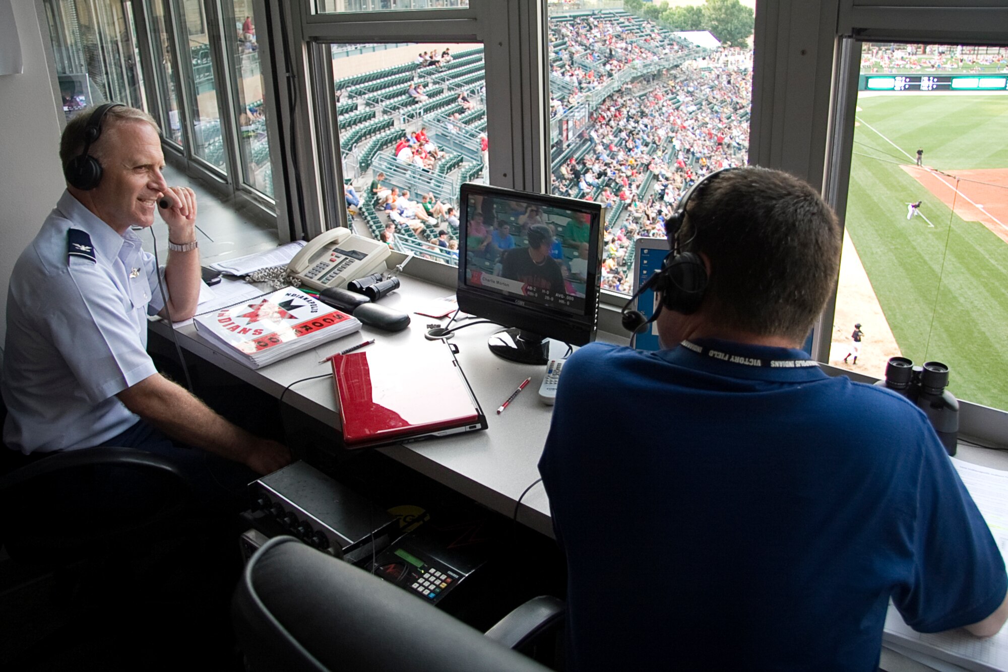 GRISSOM AIR RESERVE BASE, Ind. -- Col. Tim Cox talks with Indianapolis Indians' broadcaster Scott McCauley during a game July 22. Colonel Cox, the 434th Air Refueling Wing vice commander,  and other Grissom reservists participated in events throughout the game. (U.S. Air Force photo/Tech. Sgt. Mark R. W. Orders-Woempner)