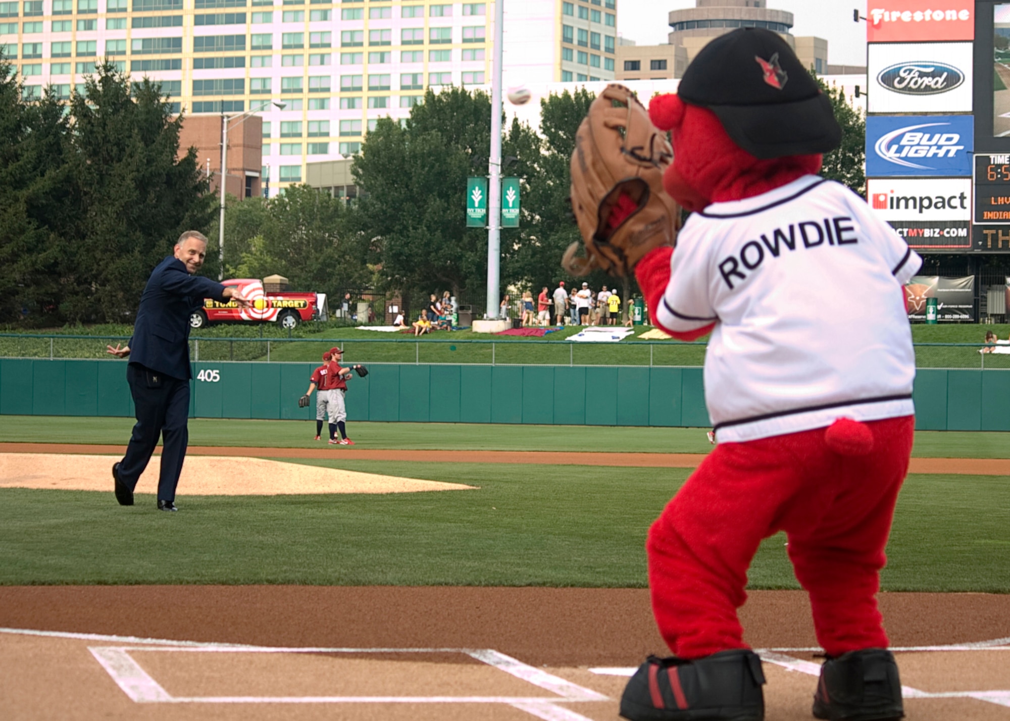 GRISSOM AIR RESERVE BASE, Ind. -- Col. Tim Cox, 434th Air Refueling Wing vice commander, throws out a ceremonial first pitch to Rowdie, the Indianapolis Indians' mascot. Colonel Cox, along with other members of the 434th ARW took part in opening ceremonies at the game. (U.S. Air Force photo/Tech. Mark R. W. Orders-Woempner)