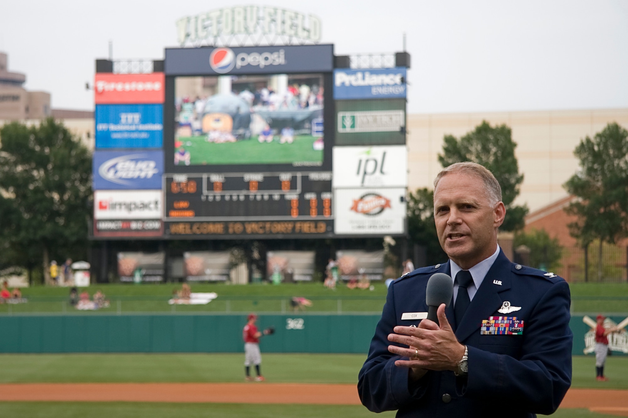 GRISSOM AIR RESERVE BASE, Ind. -- Col. Tim Cox, 434th Air Refueling Wing vice commander, tells Indianapolis Indians fans about a KC-135R Stratotanker cockpit and boompod display located outside center field before a baseball game July 22. (U.S. Air Force photo/Tech. Sgt. Mark R. W. Orders-Woempner)