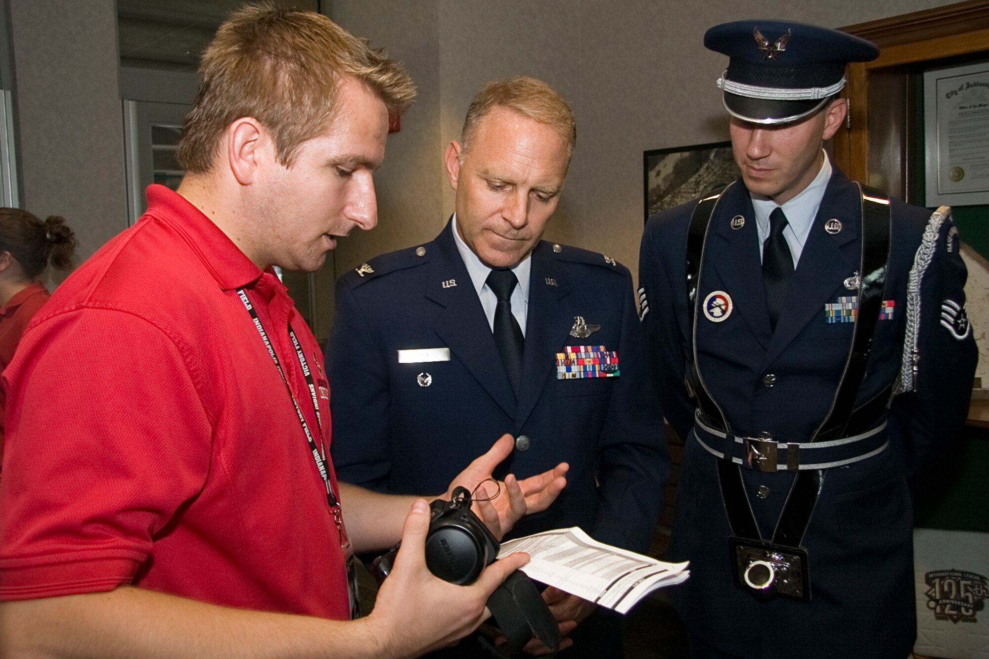 GRISSOM AIR RESERVE BASE, Ind. -- Bob Woelfel (left) goes over the order of pregame events with Col. Tim Cox and Staff Sgt. Ben Durr before an Indianapolis Indians game July 22. Colonel Cox, the 434th Air Refueling Wing vice commander, and Sergeant Durr, a member of the Grissom Base Honor Guard to park in pregame ceremonies. Mr. Woelfel is a sponsorship sales executive with the Indians.  (U.S. Air Force photo/Tech. Sgt. Mark R. W. Orders-Woempner)