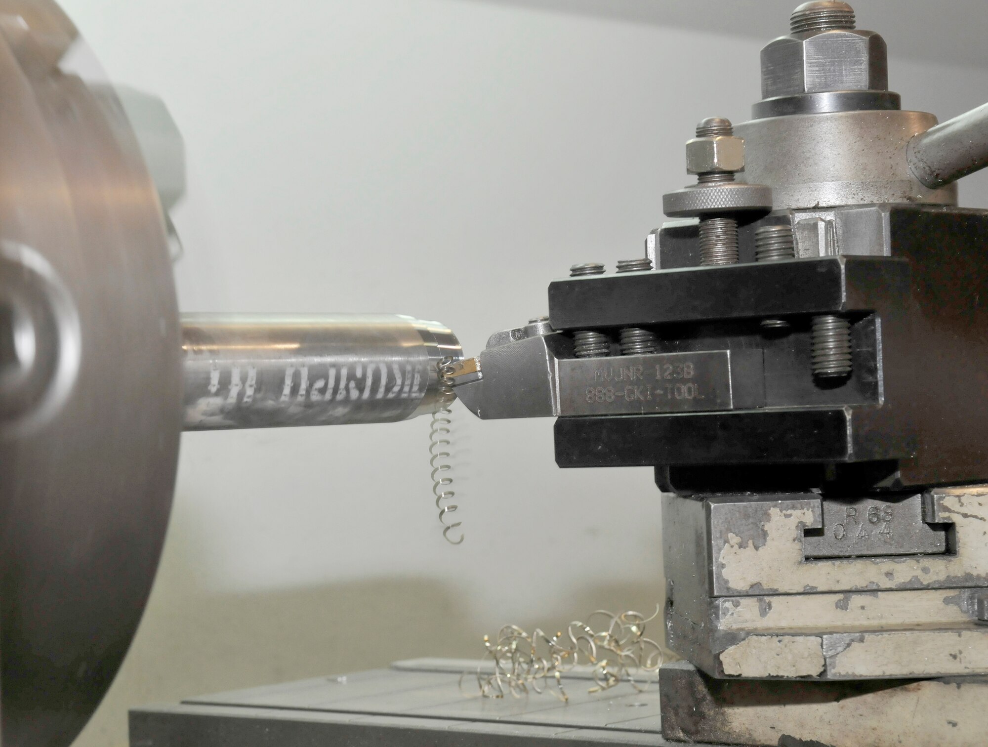 The metal lathe used at the 332nd Maintenance Squadron metals technology flight is able to turn and cut any piece of metal a technician can place in its three-jaw chuck. The lathe uses dies that are made out of hardened metals, such as tungsten carbide, and it can cut a piece of metal to an accuracy of a 1,000th of an inch. (U.S. Air Force photo/ Staff Sgt. Phillip Butterfield)