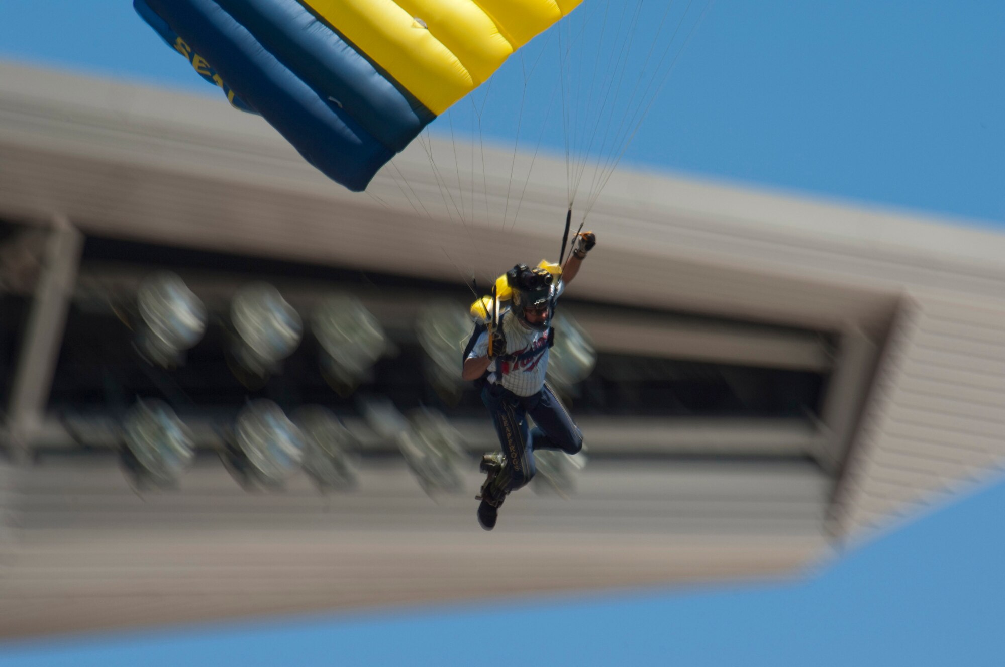 After jumping out of a 133rd Airlift Wing C-130, a member of the U. S. Navy parachute team "Leap Frogs" wearing a Twins jersey glides into Target Field on July 21, 2010. The Minnesota Twins are celebrating Navy Day in their new stadium. The Air National Guard crew is joined by aviators from the 934th Airlift Wing, U. S. Air Force Reserve supporting this event.  USAF official photo by Senior Master Sgt. Mark Moss