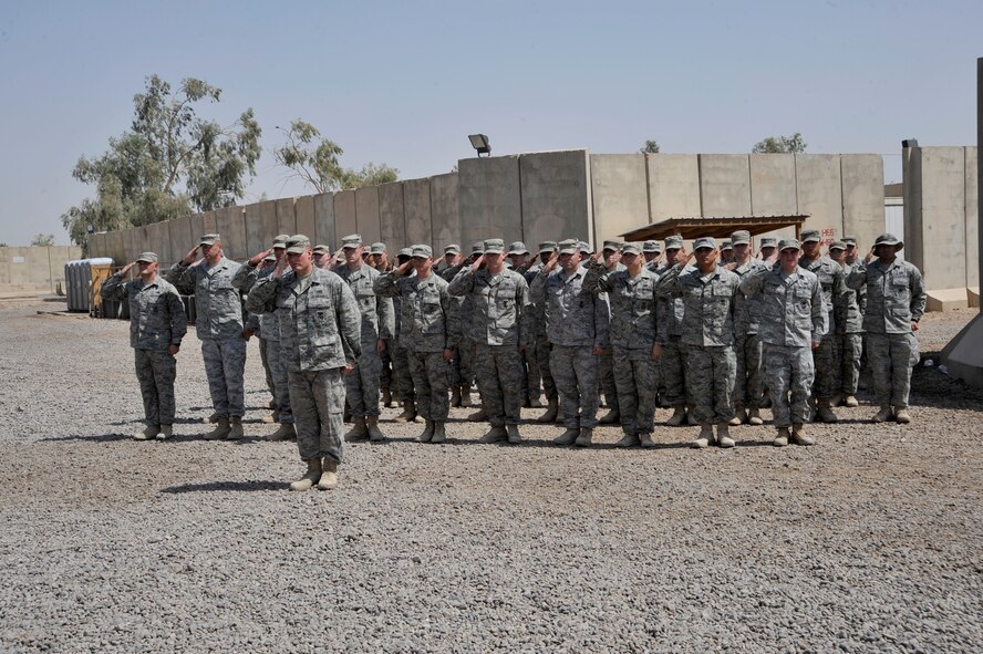 Airmen from the 732nd Expeditionary Security Forces Squadron, Det. 2, give a final salute to Maj. David Lederer during the deactivation of the 732nd ESFS, Det. 2, and the transfer of authority of the police transition team mission to the Army's 94th Military Police Company July 26, 2010, at Camp Stryker, Iraq. Major Lederer is the 732nd ESFS, Det. 2, commander. ( U.S. Air Force photo/Perry Aston) 
