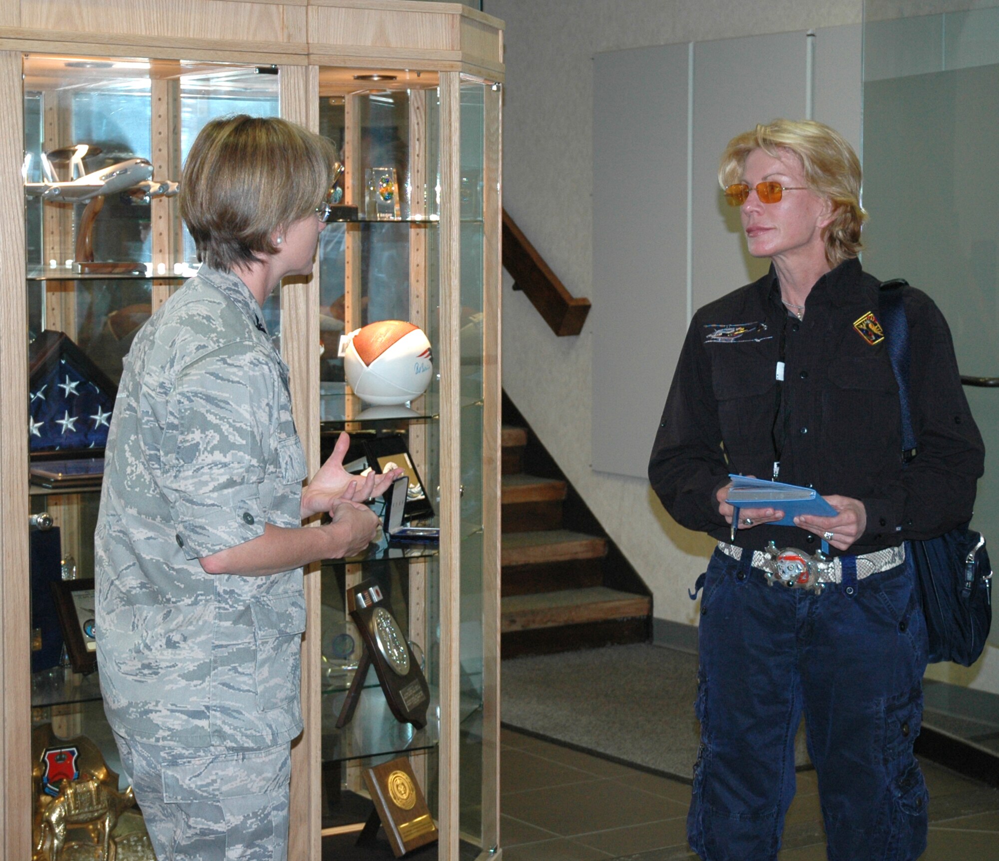 Patricia Cornwell and Col. Stacy L. Yike, 66th Air Base Group commander, discuss the base's mission in the Electronic Systems Center headquarters lobby on July 26. (U.S. Air Force photo by Sarah Olaciregui) 
