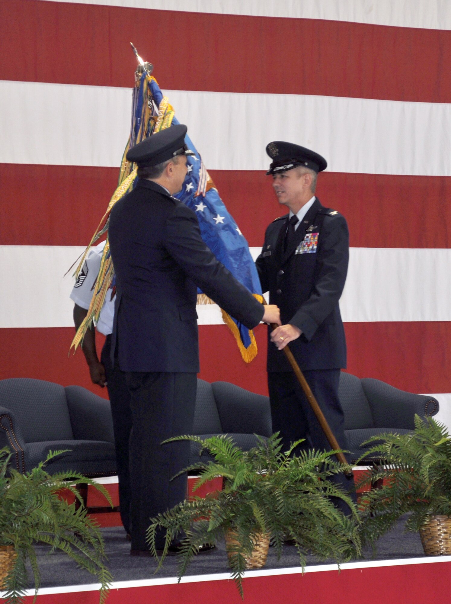Col. Barre Seguin, the new 14th Flying Training Wing Commander receives the 14th Flying Training Wing guidon from Maj. Gen. Feest during the change of command ceremony on July 28, 2010. The passing of the guidon symbolizes the transfer of command from one individual to another. (U.S. Air Force photo/Airman 1st Class Chase Hedrick)