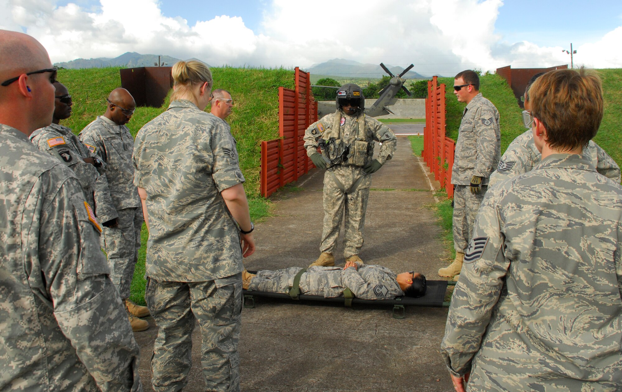 SOTO CANO AIR BASE, Honduras --  Staff Sgt. Shontal Thompson, a 1-228th Aviation Regiment flight medic, goes over loading and unloading procedures with Medical Element personnel during a HOT/COLD aircraft loading class here July 27. The MEDEL has had more than 90 percent turn-over in personnel recently, which necessitated updated training. (U.S. Air Force photo/Tech. Sgt. Benjamin Rojek)
