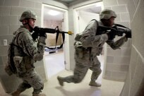Airman 1st Class Dennis Eldridge and Airman Isiah Fowler, both Security Forces Apprentice students with the 343rd Training Squadron, clear the stairwells of a building during an excercise at the Urban Operations Facility at Camp Bullis July 14. (U.S. Air Force photo/Robbin Cresswell)