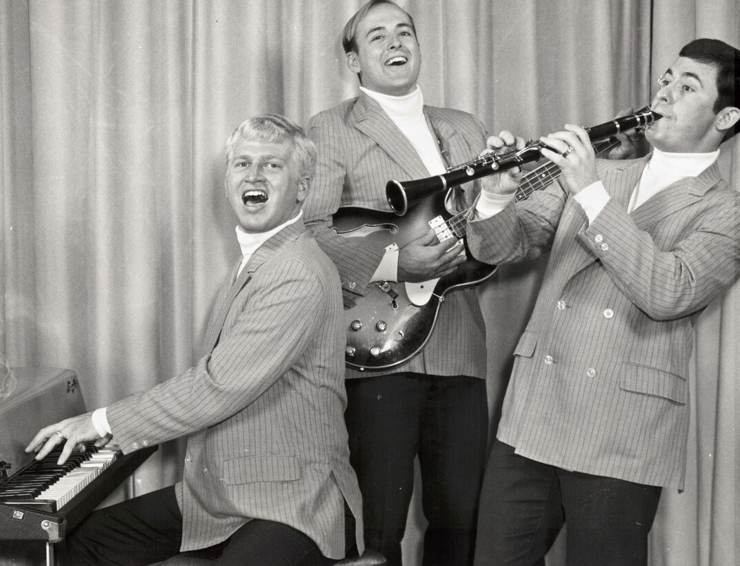 Members of “The Good Timers,” a unit of The United States Air Force Band, pose for a promotional photograph prior to their 1971 PACAF Tour.  Pat Hamilton at the piano, Jarrel Elliott (guitar) and Clark Walter (clarinet).  If you have additional information about the event or the members featured, please email our Band Historian <a href="mailto:usafbandhistorian@afncr.af.mil">Technical Sgt. Tracey MacDonald</a>.  This is Photo 35. (Unknown Photographer)