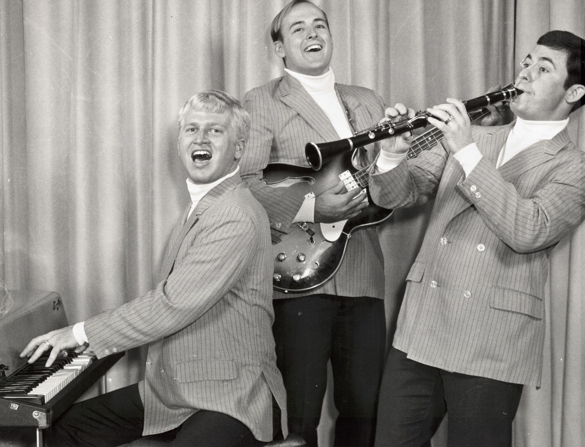 Members of “The Good Timers,” a unit of The United States Air Force Band, pose for a promotional photograph prior to their 1971 PACAF Tour.  Pat Hamilton at the piano, Jarrel Elliott (guitar) and Clark Walter (clarinet).  If you have additional information about the event or the members featured, please email our Band Historian <a href="mailto:usafbandhistorian@afncr.af.mil">Technical Sgt. Tracey MacDonald</a>.  This is Photo 35. (Unknown Photographer)