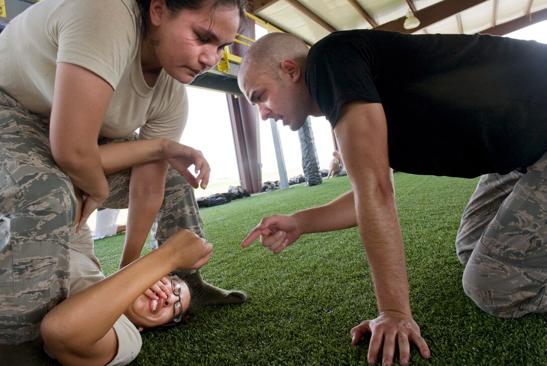 An instructor walks a ROTC cadet through the process of performing an arm bar on another cadet July 22, 2010, at Maxwell Air Force Base, Ala. The cadets learned extensive techniques and skills that will help them defend themselves in combat situations. (U.S. Air Force photo/Senior Airman Christopher Griffin)