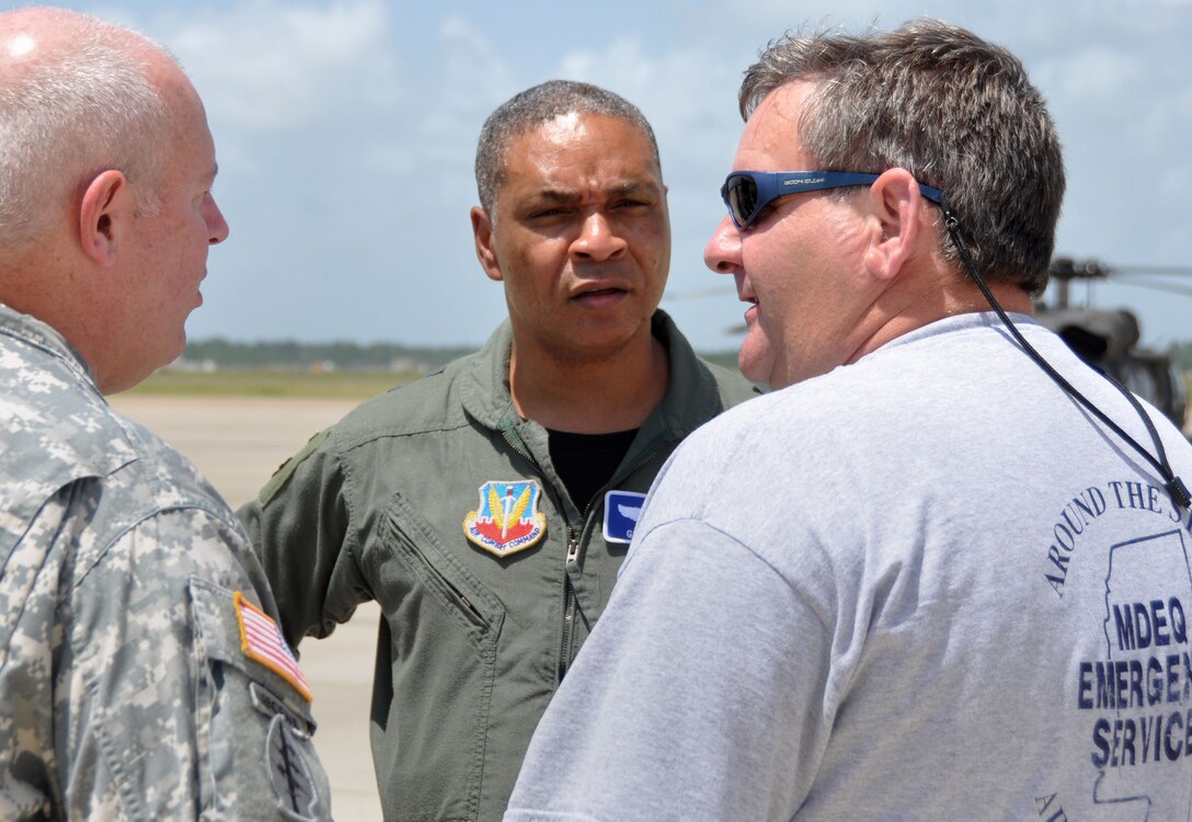 Air Forces Northern commander Maj. Gen. Garry C. Dean (center) speaks with Lt. Col. Don Randle (left), Task Force Vigilant Horizon, and Earl Etheridge of the Mississippi Department of Environmental Quality, about his observations from a reconnaissance flight over the Mississippi Gulf Coast aboard a UH-72 Lakota. (Mississippi Army National Guard photo by Casey Ware)