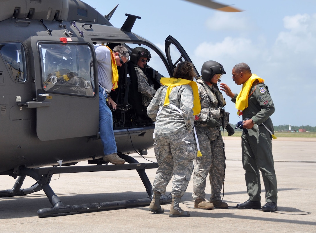 Air Forces Northern commander Maj. Gen. Garry C. Dean thanks the flight engineer of a UH-72 Lakota helicopter after participating in a recent reconnaissance flight over the Mississippi Gulf Coast. (Mississippi Army National Guard photo by Casey Ware)