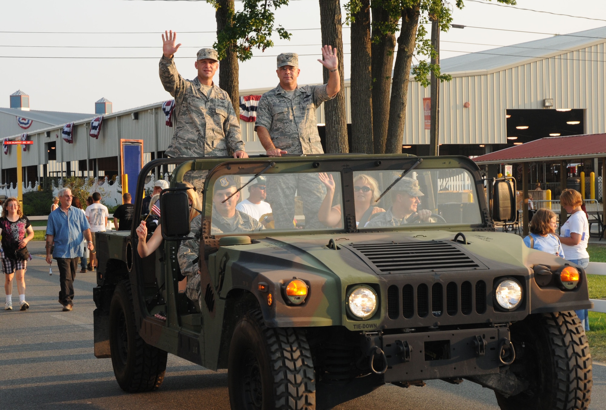 Col. Randal L. Bright (right), 512th Airlift Wing commander, and Col. Anthony Krawietz, 436th AW vice commander, wave to the crowd during the 7 p.m. parade at the Delaware State Fair in Harrington, Del., July 28.  It was Armed Forces Day at the fair. Military members received free admission. (U.S. Air Force photo/Capt. Marnee A.C. Losurdo)