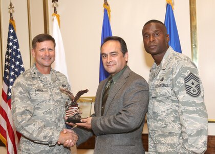Michael Valdez receives the Civilian of the Quarter Category II award from Brig. Gen. Leonard Patrick, 502nd Air Base Wing commander, and Chief Master Sgt. Juan Lewis, 502nd ABW command chief, during the 502nd ABW second quarter awards luncheon July 27 at the Kelly Club. Mr. Valdez is with the 802nd Comptroller Squadron. (U.S. Air Force photo/Robbin Cresswell)