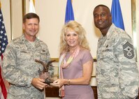 Tracy Kreusler receives the Civilian Supervisor of the Quarter Category I award from Brig. Gen. Leonard Patrick, 502nd Air Base Wing commander, and Chief Master Sgt. Juan Lewis, 502nd ABW command chief, during the 502nd ABW second quarter awards luncheon July 27 at the Kelly Club. Ms. Kreusler is with the 902nd Logistics Readiness Squadron. (U.S. Air Force photo/Robbin Cresswell)